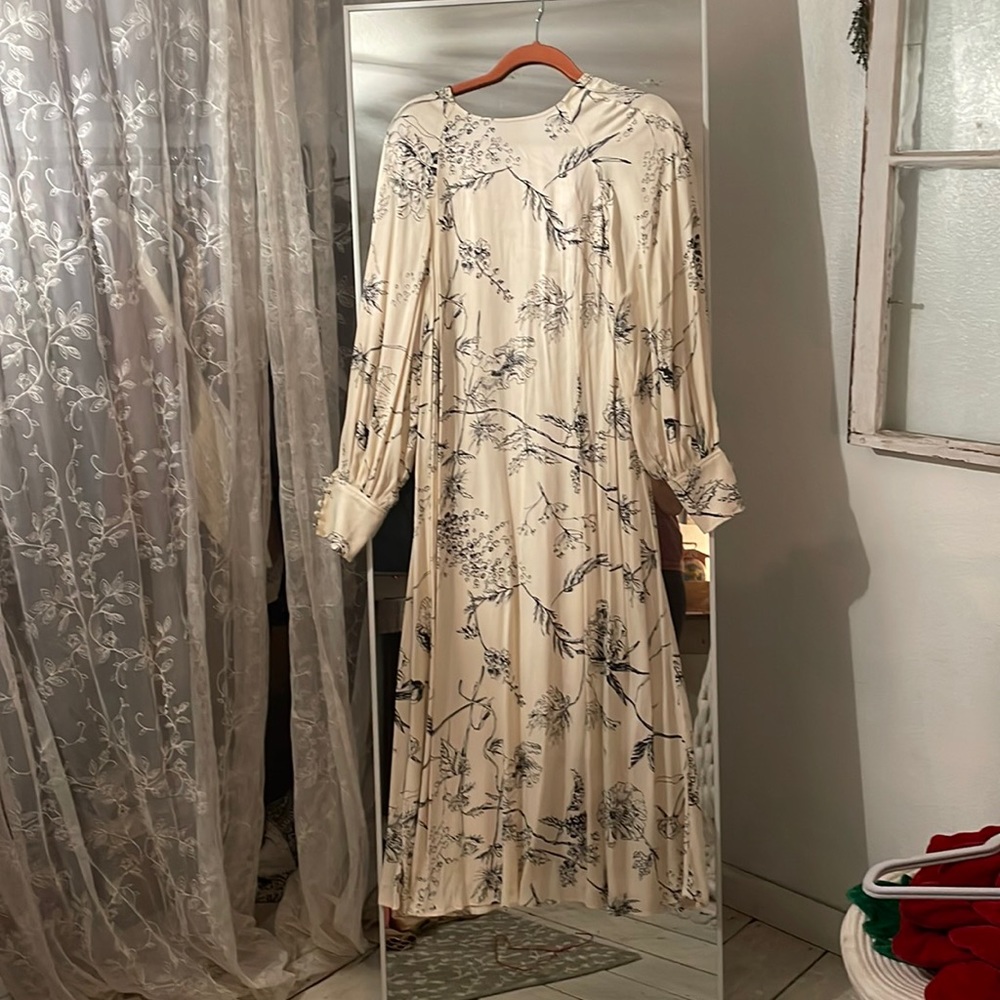New with tags, silky material but not flimsy.Very well made dress, flowey.